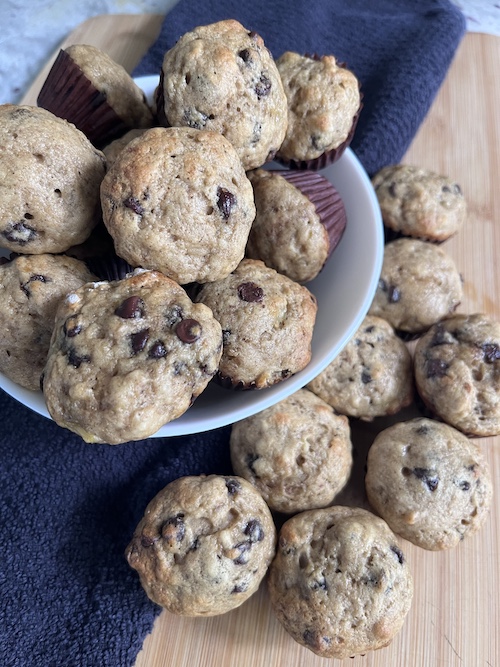 Chocolate chip mini muffins overflowing a bowl